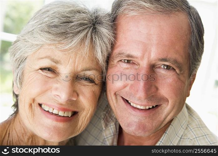 Couple relaxing indoors smiling