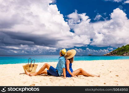 Couple relaxing on a tropical beach Anse Intendance at Seychelles, Mahe.