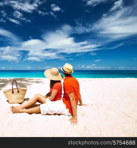 Couple relaxing on a tropical beach Anse Intendance at Seychelles, Mahe.