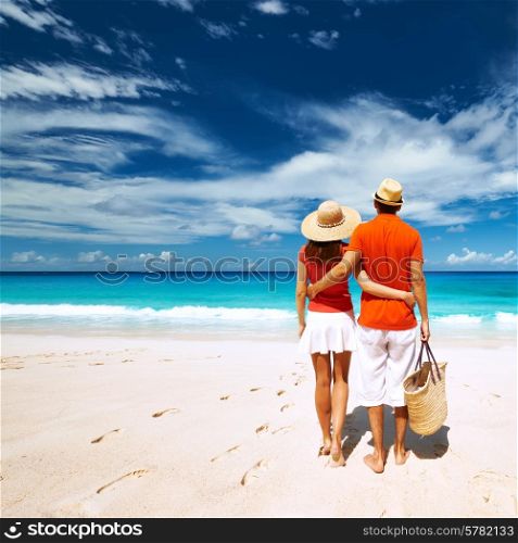 Couple relaxing on a tropical beach Anse Intendance at Seychelles, Mahe.