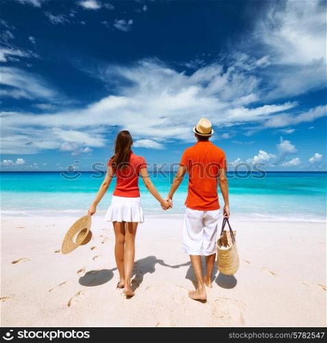 Couple relaxing on a tropical beach Anse Intendance at Seychelles, Mahe.
