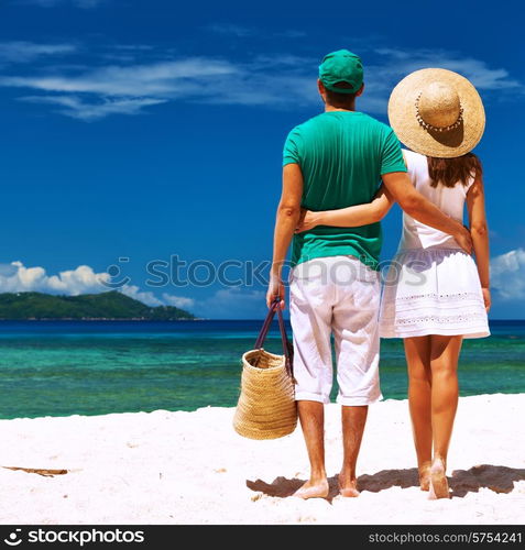 Couple relaxing on a tropical beach at Seychelles, La Digue.