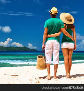 Couple relaxing on a tropical beach at Seychelles, La Digue.