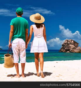 Couple relaxing on a tropical beach at Seychelles, La Digue.