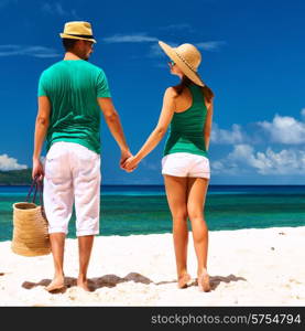 Couple relaxing on a tropical beach at Seychelles, La Digue.