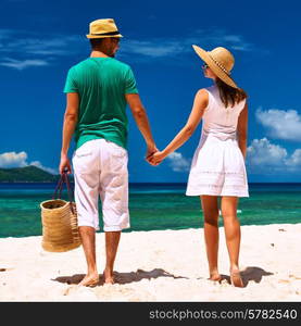 Couple relaxing on a tropical beach at Seychelles, La Digue.