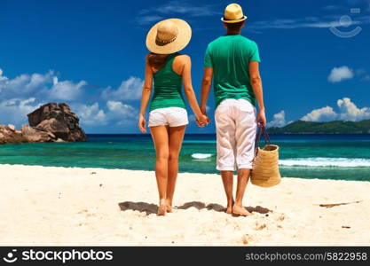 Couple relaxing on a tropical beach at Seychelles, La Digue.