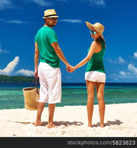 Couple relaxing on a tropical beach at Seychelles, La Digue.