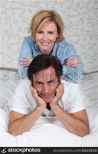 Couple relaxing on bed