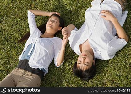 Couple relaxing on grass
