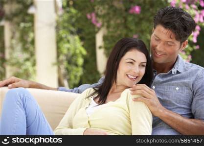 Couple Relaxing On Sofa At Home