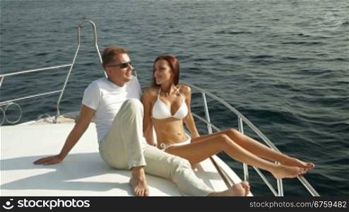 Couple relaxing on the deck of luxury yacht