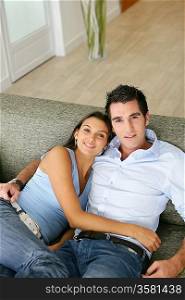 Couple relaxing on their sofa