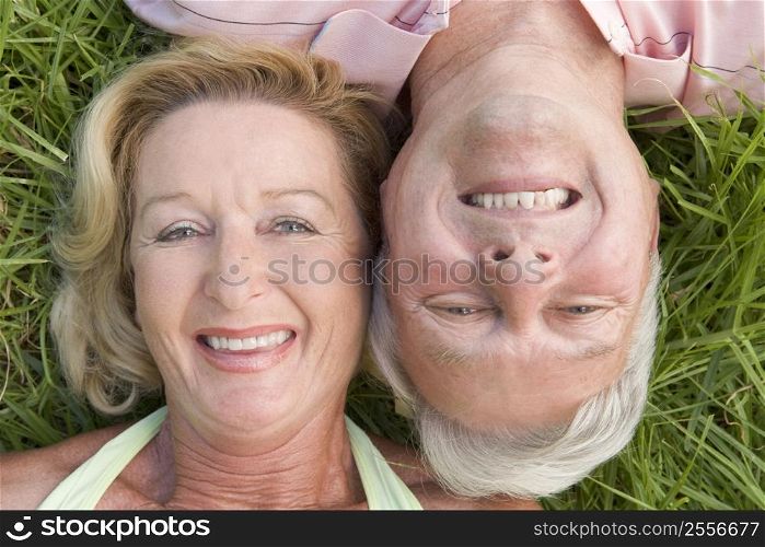 Couple relaxing outdoors and smiling