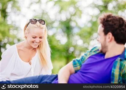 Couple relaxing outdoors talking and smiling
