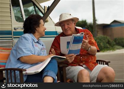 Couple Relaxing Outside Their RV