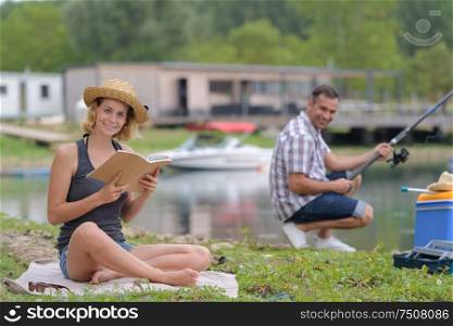 couple relaxing while fishing at the lake