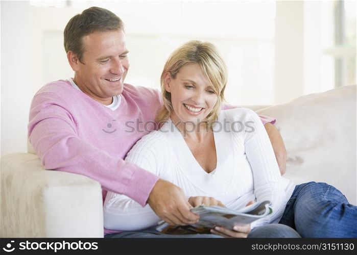 Couple relaxing with a magazine and smiling