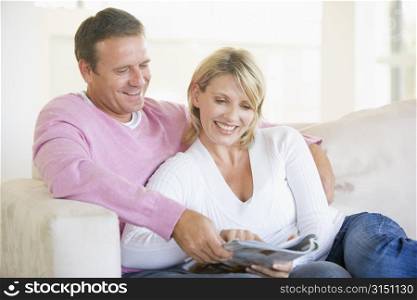 Couple relaxing with a magazine and smiling