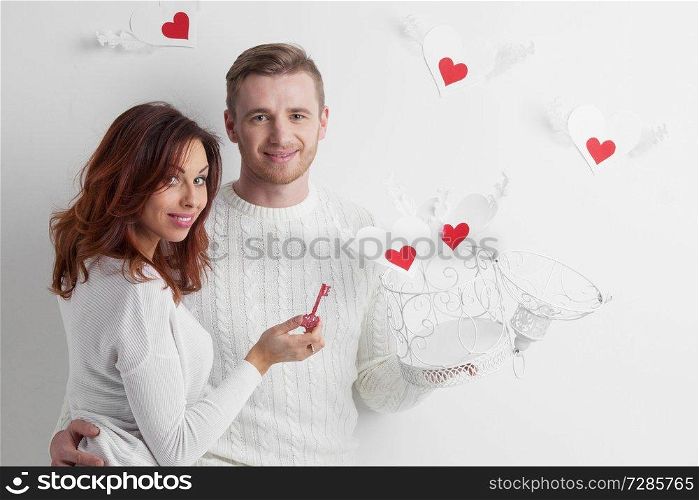 Couple releasing love, man and woman open cage with winged hearts, valentines day concept. Couple releasing love