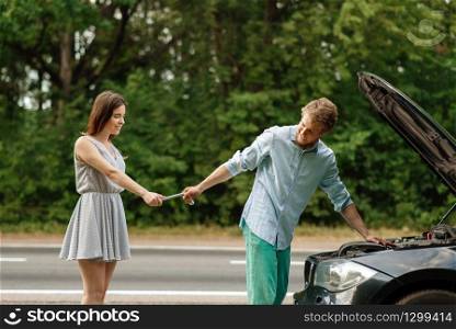 Couple repair auto on road, car breakdown. Broken automobile or emergency accident with vehicle, trouble with engine on highway