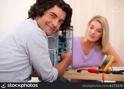 Couple repairing computer
