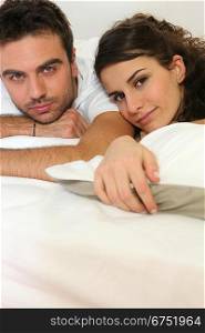 Couple resting in bed