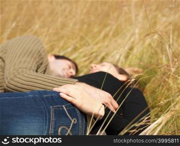 Couple resting in field