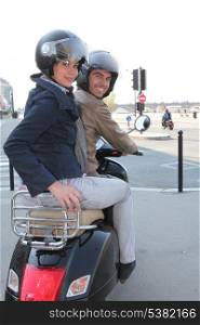 Couple riding a scooter