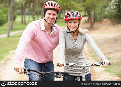 Couple riding bicycle in park