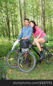 Couple riding bike in countryside