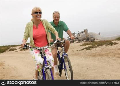Couple Riding Bikes along Beach