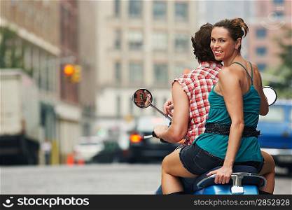 Couple Riding on Scooter Together
