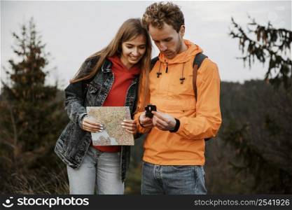 couple road trip together with compass map