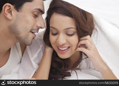 Couple romancing in bed