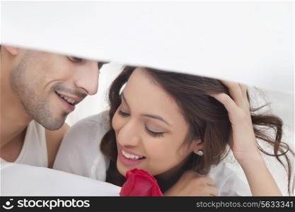 Couple romancing in bed