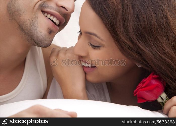 Couple romancing in bed