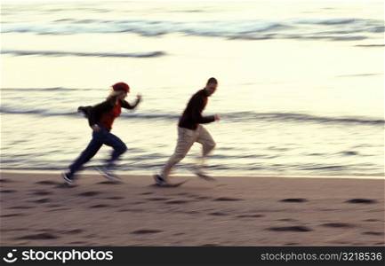 Couple Running Along Beach