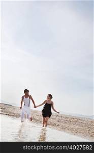 couple running along the beach