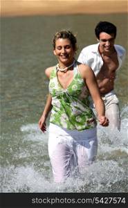 Couple running in the water