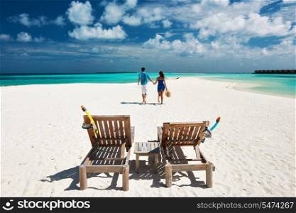 Couple running on a tropical beach at Maldives