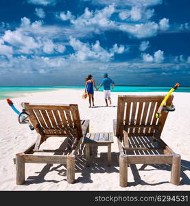 Couple running on a tropical beach at Maldives