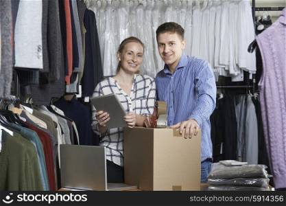 Couple Running On Line Clothing Store Packing Goods For Dispatch