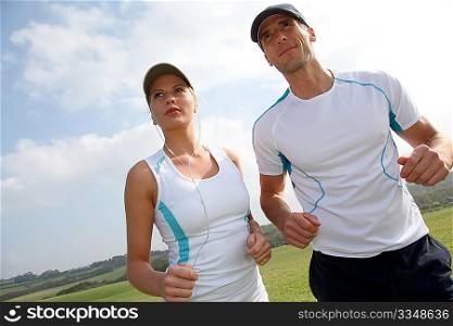 Couple running outside on a sunny day