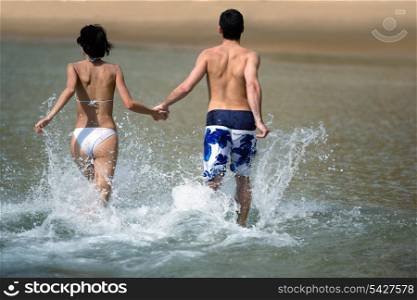 Couple running through the water
