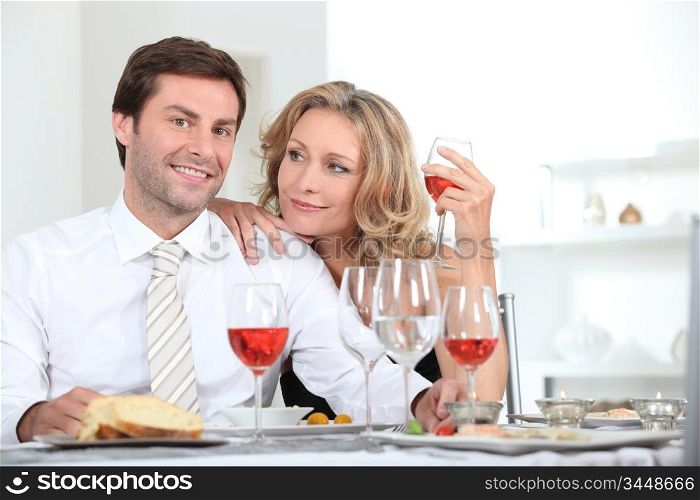 Couple sat at table with wine