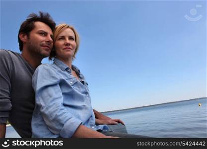 Couple sat by water