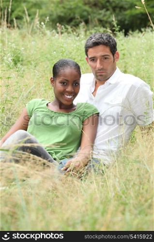 Couple sat in a field