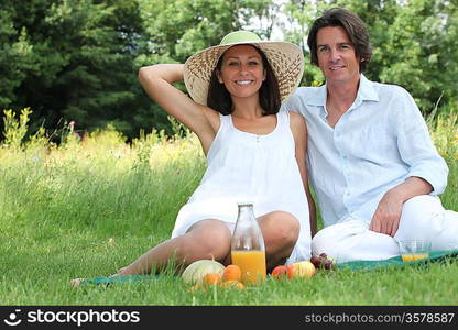 Couple sat in field