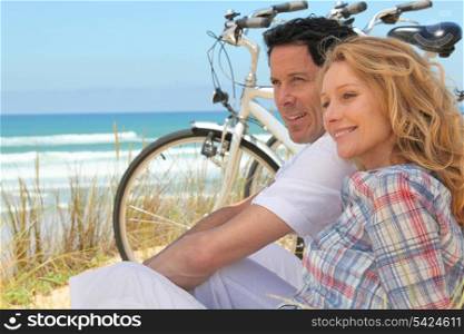 Couple sat next to bicycles